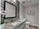 Stylish powder room with granite countertop and mosaic tile accent wall at 1168 Atcheson Ln, Atlanta, GA 30338