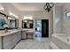 Stylish bathroom boasts dual sinks, granite counters, and adjacent tub at 1168 Atcheson Ln, Atlanta, GA 30338