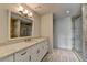 Bright bathroom features white cabinets, granite countertops, a glass shower and large mirror at 1168 Atcheson Ln, Atlanta, GA 30338