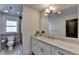 Bathroom showcasing granite countertops, white cabinetry, a toilet, and a window for natural light at 1168 Atcheson Ln, Atlanta, GA 30338