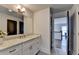 Bathroom featuring granite countertops, white cabinetry, and a view of the staircase from the doorway at 1168 Atcheson Ln, Atlanta, GA 30338