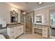 Bathroom featuring granite countertops and a glass shower plus a lighted makeup vanity and access to the bedroom at 1168 Atcheson Ln, Atlanta, GA 30338