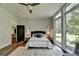 Stylish bedroom featuring a neutral color palette and large windows with backyard views at 1168 Atcheson Ln, Atlanta, GA 30338