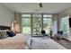 Comfortable bedroom featuring large windows overlooking the backyard at 1168 Atcheson Ln, Atlanta, GA 30338