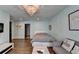 Bedroom with light blue walls, hardwood floors, a crystal chandelier, and a couch for relaxing at 1168 Atcheson Ln, Atlanta, GA 30338
