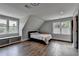 Spacious bedroom featuring hardwood floors, a window seat, three large windows, and an airy atmosphere at 1168 Atcheson Ln, Atlanta, GA 30338