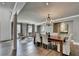 Bright dining room with chandelier lighting, wood floors, and a sitting area with armchairs at 1168 Atcheson Ln, Atlanta, GA 30338