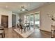 Dining space with glass table, modern lighting, and sliding doors that seamlessly blend indoor and outdoor spaces at 1168 Atcheson Ln, Atlanta, GA 30338