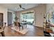 Bright dining room features modern glass table and seamless transition to a screened outdoor living space at 1168 Atcheson Ln, Atlanta, GA 30338