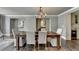 Elegant dining room featuring a chandelier, seating for six, and hardwood flooring at 1168 Atcheson Ln, Atlanta, GA 30338