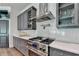 Gourmet kitchen features stainless steel range, gray cabinets, and stylish countertops at 1168 Atcheson Ln, Atlanta, GA 30338
