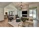 Bright living room boasts an elegant chandelier, modern fireplace, and glass doors to the backyard at 1168 Atcheson Ln, Atlanta, GA 30338