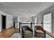 Spacious loft area with hardwood floors, two chairs, staircase with white balusters, and a decorative chandelier at 1168 Atcheson Ln, Atlanta, GA 30338