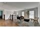 Open loft area showcasing hardwood floors, stylish seating, and staircase with white balusters at 1168 Atcheson Ln, Atlanta, GA 30338