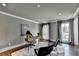 Home office featuring a modern desk, two chairs, and natural light from the windows at 1168 Atcheson Ln, Atlanta, GA 30338