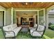 Inviting covered patio with seating area that is open to the kitchen via sliding glass doors at 1168 Atcheson Ln, Atlanta, GA 30338
