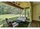 Relaxing covered patio featuring outdoor seating, ceiling fan, and view of expansive, green backyard at 1168 Atcheson Ln, Atlanta, GA 30338