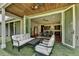 Inviting covered patio with seating area that is open to the kitchen via sliding glass doors at 1168 Atcheson Ln, Atlanta, GA 30338