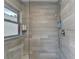 Bathroom shower featuring gray tile walls, a glass enclosure, and a shower head at 1168 Atcheson Ln, Atlanta, GA 30338