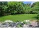 Well-maintained backyard with a large, open grassy area, surrounded by lush greenery and a fence at 1202 Key Se Rd, Atlanta, GA 30316