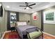 Comfortable bedroom featuring hardwood floors, a ceiling fan, and two windows for natural light at 1202 Key Se Rd, Atlanta, GA 30316