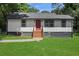 Charming home with a freshly painted exterior and a vibrant red front door, set on a well-manicured lawn at 1202 Key Se Rd, Atlanta, GA 30316