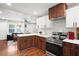 Modern kitchen showcasing stainless steel appliances and island counter, with an open view to the living area at 1202 Key Se Rd, Atlanta, GA 30316