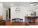 View of the entry and kitchen area with bar seating, hardwood floors, and decoratively paneled wall at 1202 Key Se Rd, Atlanta, GA 30316