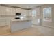 Bright kitchen features white cabinets, stainless steel appliances, and a large kitchen island at 2485 Dixon Pl, Lawrenceville, GA 30045