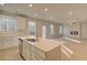 View of the kitchen island with stainless steel appliances and open view to the living space at 2485 Dixon Pl, Lawrenceville, GA 30045
