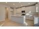 Bright kitchen features white cabinets, stainless steel appliances, and center island with sink at 2485 Dixon Pl, Lawrenceville, GA 30045