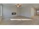 Cozy living room featuring modern fireplace, hardwood floors and a ceiling fan at 2485 Dixon Pl, Lawrenceville, GA 30045
