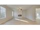 Open-concept living room with hardwood floors, modern fireplace, and a ceiling fan at 2485 Dixon Pl, Lawrenceville, GA 30045