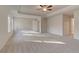 Spacious main bedroom with neutral paint, plush carpet, tray ceiling and a ceiling fan at 2485 Dixon Pl, Lawrenceville, GA 30045
