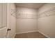 A small walk-in closet with wire shelving and neutral carpeting at 2485 Dixon Pl, Lawrenceville, GA 30045
