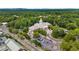 Aerial view of the Roswell library building, featuring parking and mature trees at 355 Highlands Trce, Roswell, GA 30075