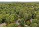 Aerial view of wooded neighborhood showcasing a home on a cul-de-sac at 355 Highlands Trce, Roswell, GA 30075