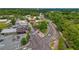 Aerial view of the commercial district with mature trees and various businesses at 355 Highlands Trce, Roswell, GA 30075