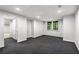 Finished basement area with carpeting, window and access to additional rooms at 355 Highlands Trce, Roswell, GA 30075