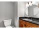 Bathroom with granite countertop and vanity with wooden cabinets at 355 Highlands Trce, Roswell, GA 30075