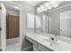 Bright bathroom with a large vanity, ample lighting, and a tub/shower combination at 355 Highlands Trce, Roswell, GA 30075