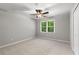 Comfortable bedroom with plush carpet, ceiling fan, and natural light at 355 Highlands Trce, Roswell, GA 30075