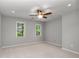 Neutral bedroom featuring a ceiling fan and a pair of bright windows at 355 Highlands Trce, Roswell, GA 30075