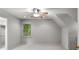 Spacious carpeted bedroom with natural light from the window and a ceiling fan at 355 Highlands Trce, Roswell, GA 30075