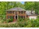 Charming brick home featuring a beautifully landscaped front yard and a classic, symmetrical design at 355 Highlands Trce, Roswell, GA 30075