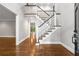 A grand foyer with hardwood floors and a staircase with decorative railings at 355 Highlands Trce, Roswell, GA 30075