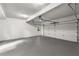 Spacious garage with a door to outside, painted walls and concrete floor at 355 Highlands Trce, Roswell, GA 30075