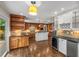 Open kitchen featuring a large island, stainless steel appliances, and hardwood floors at 355 Highlands Trce, Roswell, GA 30075