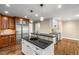 Modern kitchen features dark granite countertops, and stainless steel appliances at 355 Highlands Trce, Roswell, GA 30075