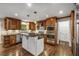Modern kitchen features light granite countertops, dark island, and stainless steel appliances at 355 Highlands Trce, Roswell, GA 30075